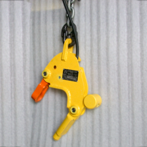 Yellow lifting clamp with an orange grip and a chain attachment, labeled Weblatch.